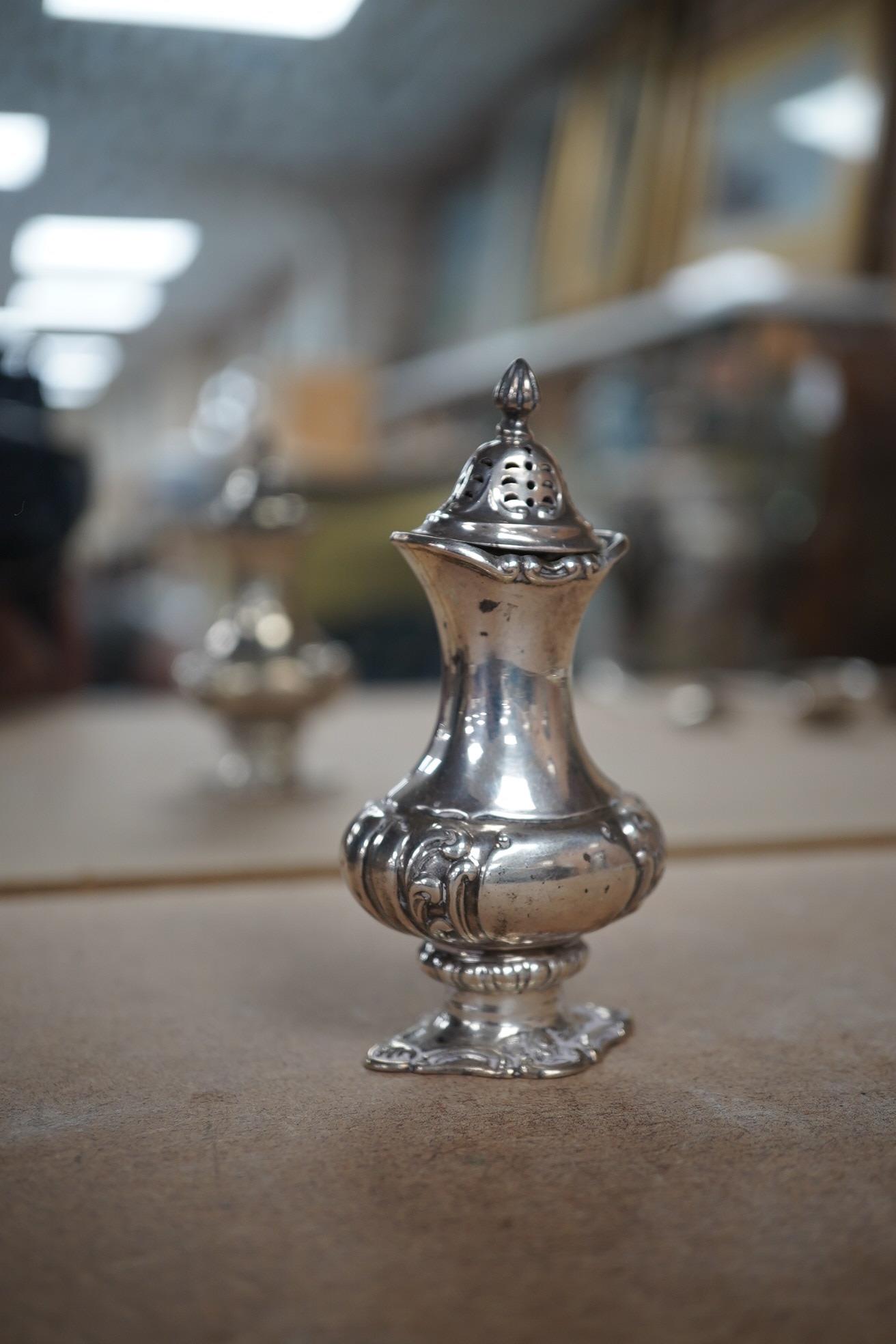 Sundry small silver including a pair of Edwardian silver drum mustards, London, 1907/8, 73mm, a Georgian pepperette, an Emes & Barnard pepperette, a Liberty & Co mustard pot, two other pepperettes and seven other items.